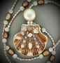 Flat Scallop Shell and freshwater coin pearl set in sterling silver and 14 karat gold on a freshwater pearl and mother of pearl chain. (1)